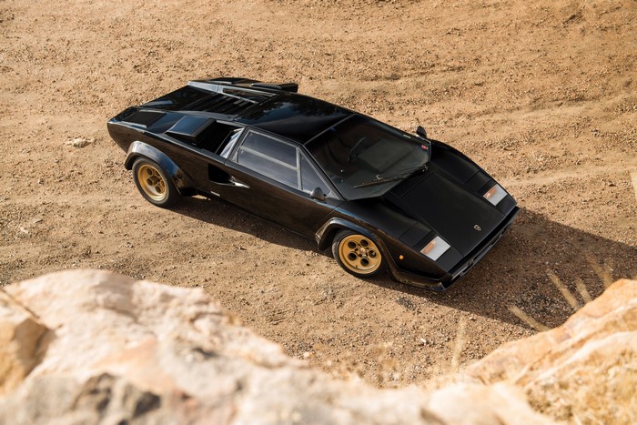 Black Lamborghini Countach LP400 S on a dirt road