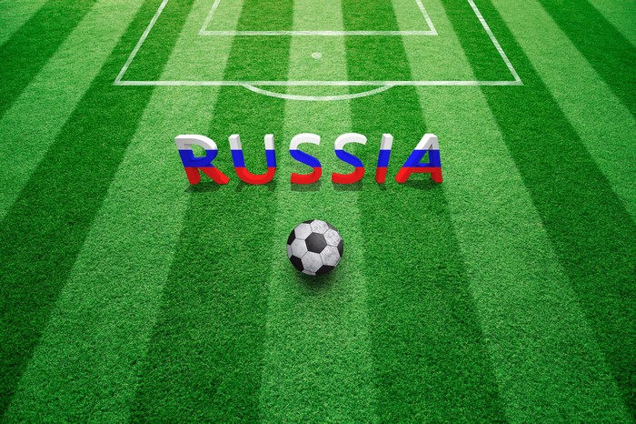 Russia word and soccer ball on a soccer field