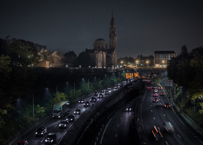 Night highway traffic in front of a church in France