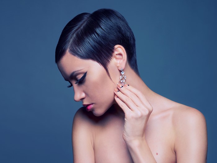 Brunette girl with earrings and makeup