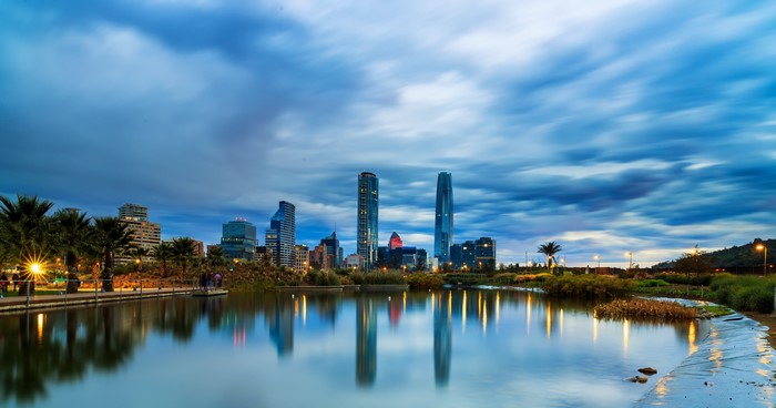 Santiago skyline with lake and palm trees at dusk
