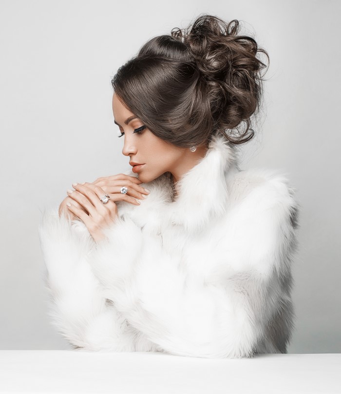 Woman in white fur coat wearing jewelry