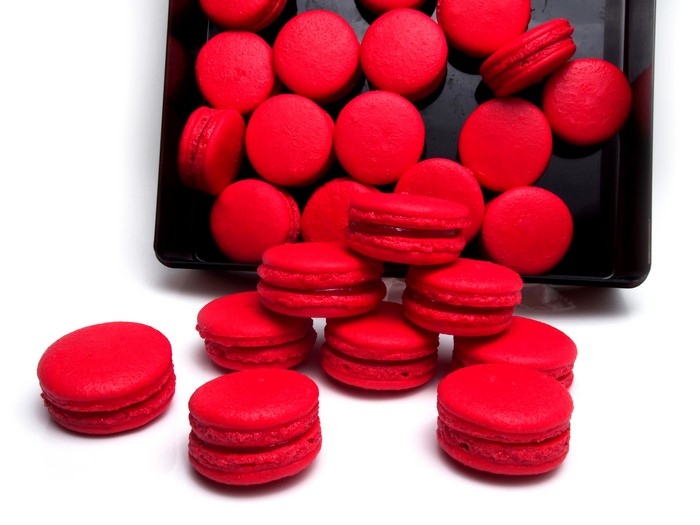 Red macarons on a white background