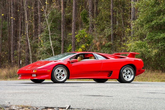 Red Lamborghini Diablo parked on asphalt road