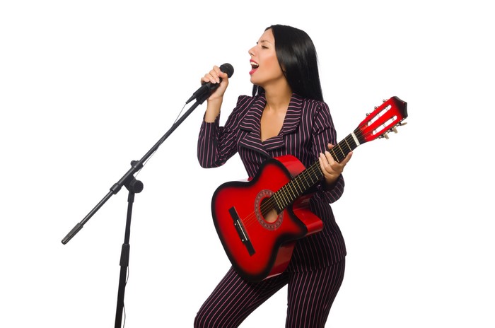 Woman singing and playing guitar