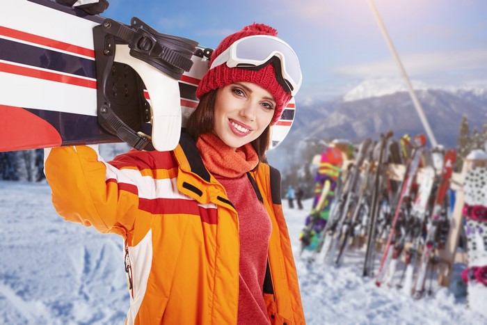 Woman with Snowboard at Ski Resort