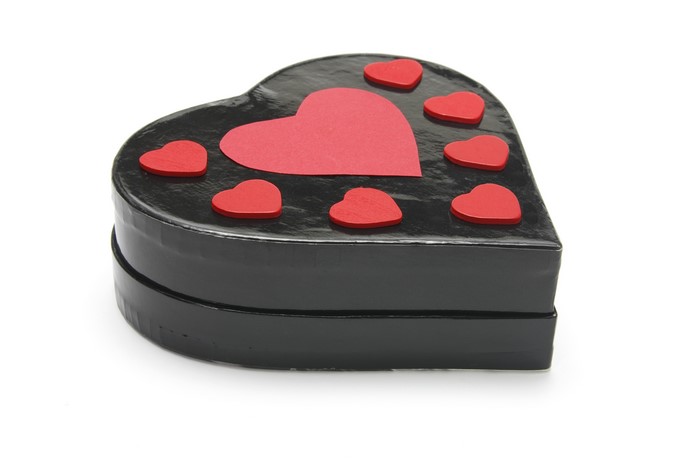 Black heart-shaped gift box with red hearts
