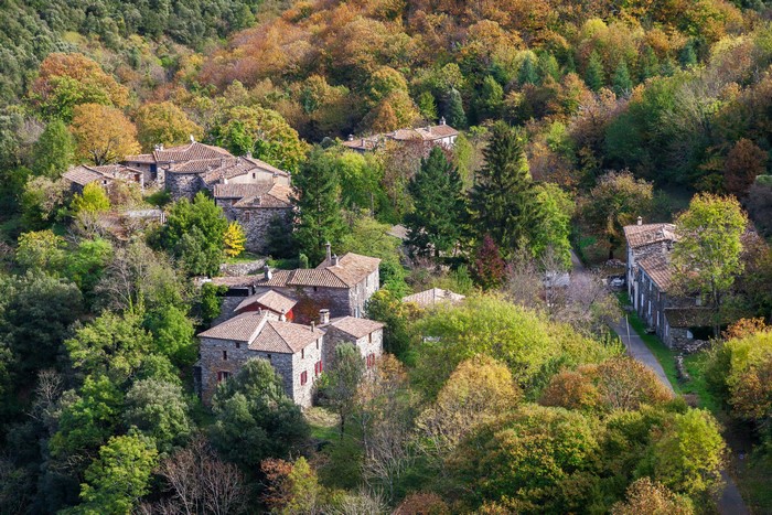 Autumn village of L'Estrechure in France surrounded by forests