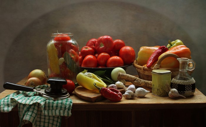 Still-life of vegetables and preserved tomatoes in a jar