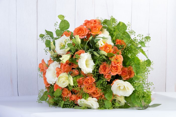 Bouquet of orange roses and white eustoma flowers