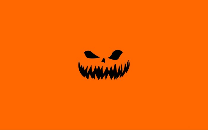 Halloween pumpkin face on orange background