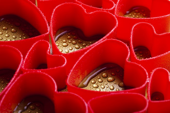 Red heart-shaped cookie cutters with water drops