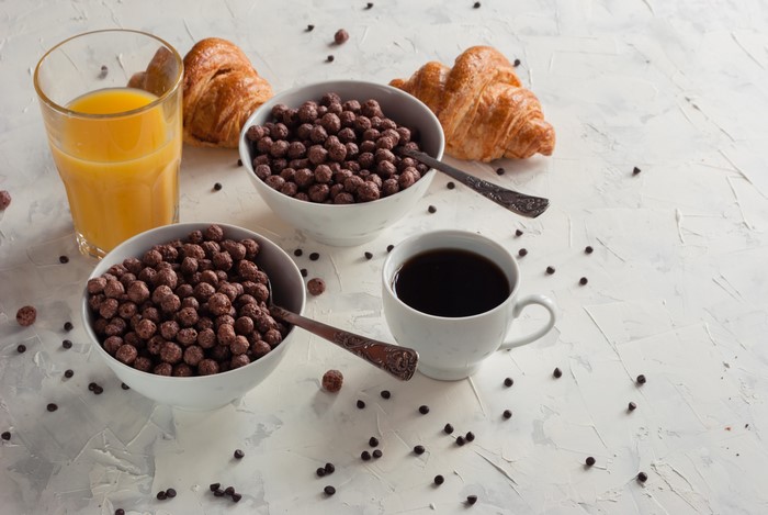 Breakfast with coffee, juice, croissants, and cereal