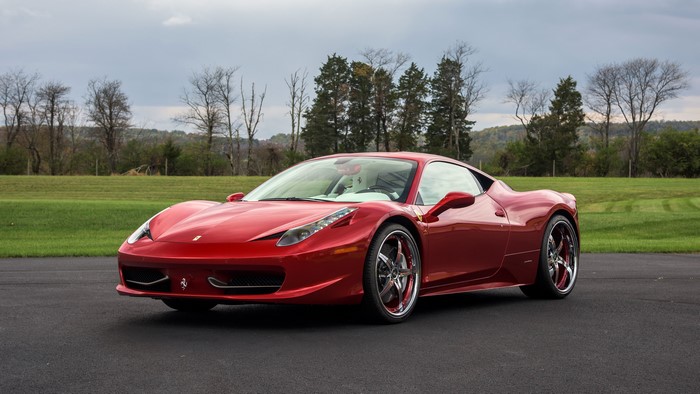 Red Ferrari 458 Italia parked on asphalt