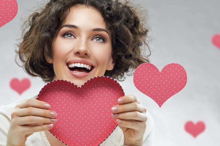 Woman holding a pink heart on Valentine's Day