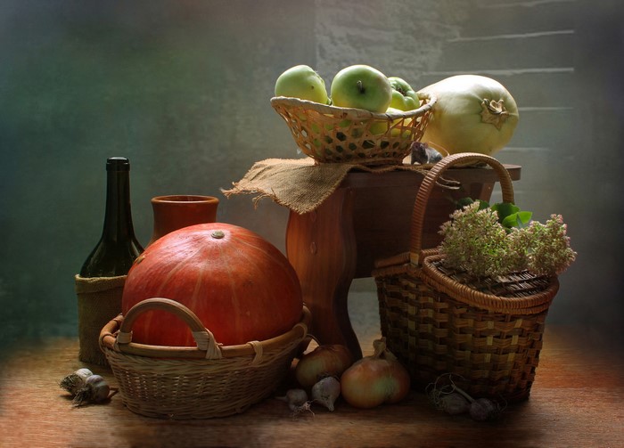 Still-life with pumpkin, apples, bottle, and wicker baskets