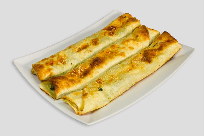 Four scallion pancakes on a white plate