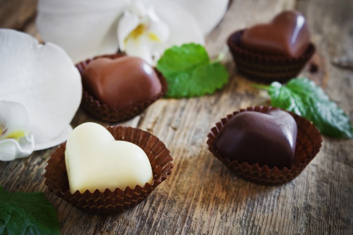Heart-shaped chocolates with orchids and mint