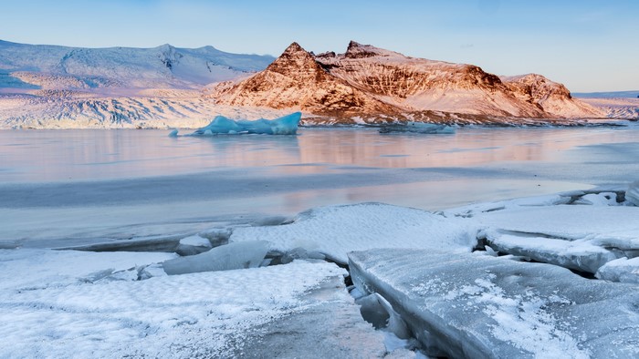Icebergs in a frozen lake with mountains in Iceland