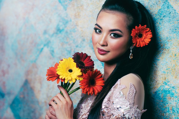 Asian woman with gerberas and makeup