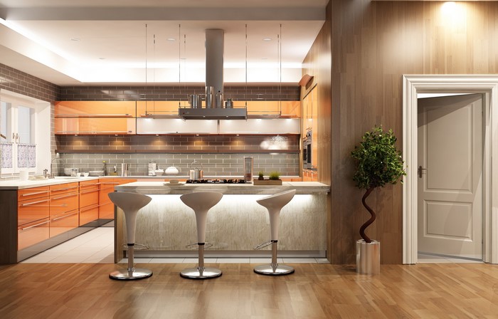 Modern Kitchen with Orange Cabinets and Island Chairs