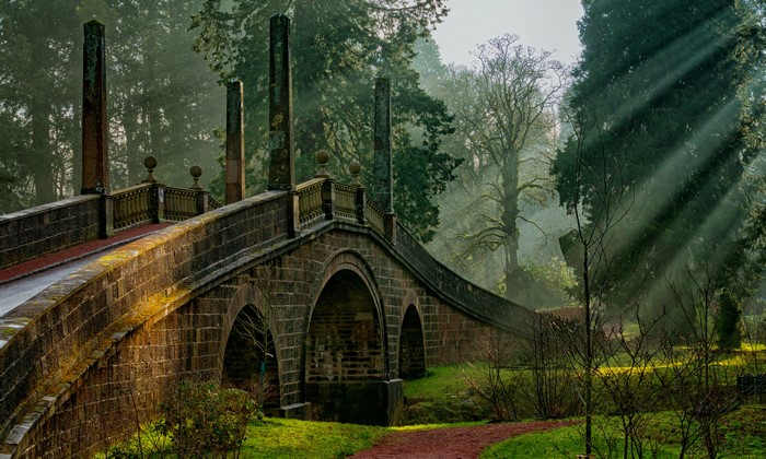 Stone bridge with sun rays at Dumfries House, Scotland