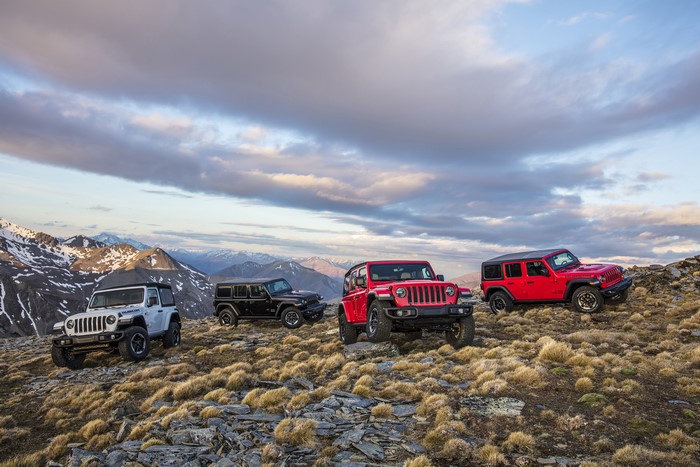 Four Jeep Wranglers on a rocky mountain landscape