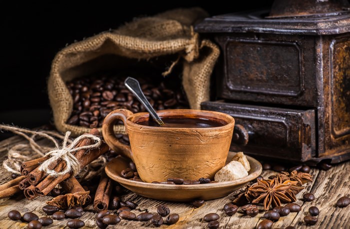 Coffee cup with beans, cinnamon, and star anise