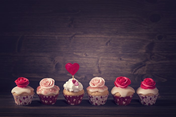 Cupcakes with Roses and Heart Decoration on Wood