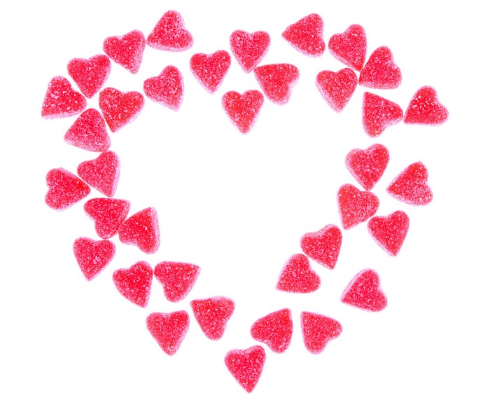 Heart-shaped red marmalade candies arranged in a heart shape