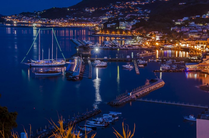 Night view of Lacco Ameno marina with yachts and sailboats