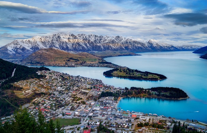 Queenstown and snow-capped mountains overlooking a lake
