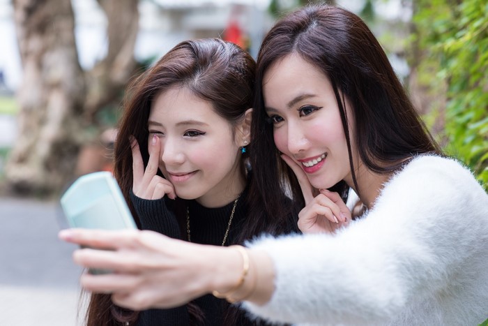 Two Asian women taking a selfie