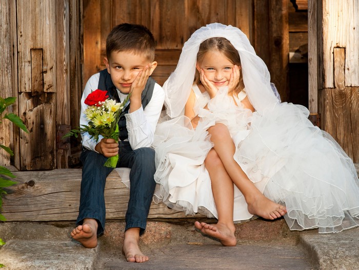 Boy and Girl Dressed as Bride and Groom with Flowers