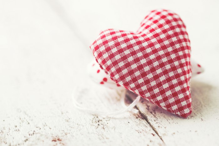 Red and white checkered heart on wood
