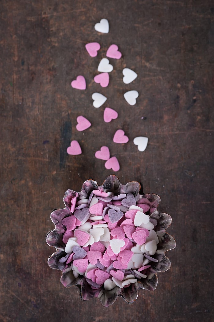 Heart-shaped candies in a fluted tin