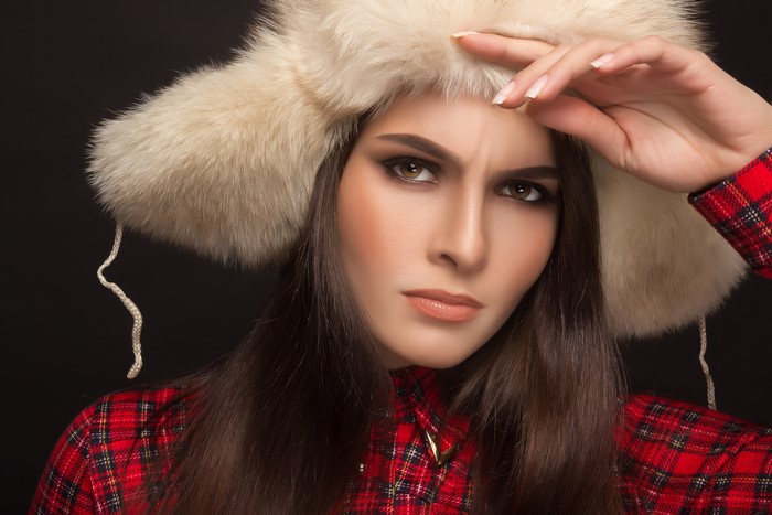 Woman in winter hat and plaid shirt
