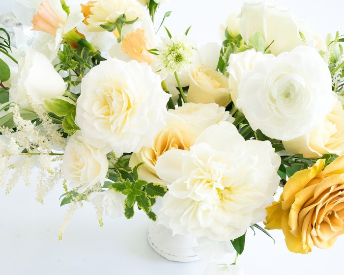 White and yellow floral arrangement in a vase