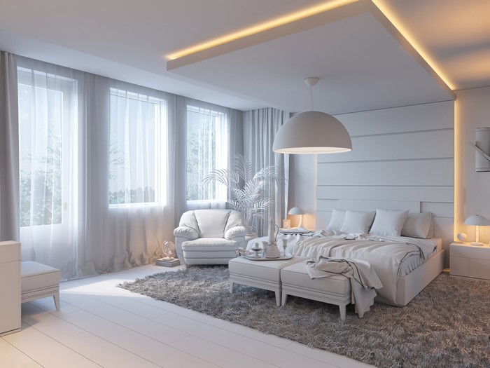 Modern bedroom with bed, armchair, and carpet