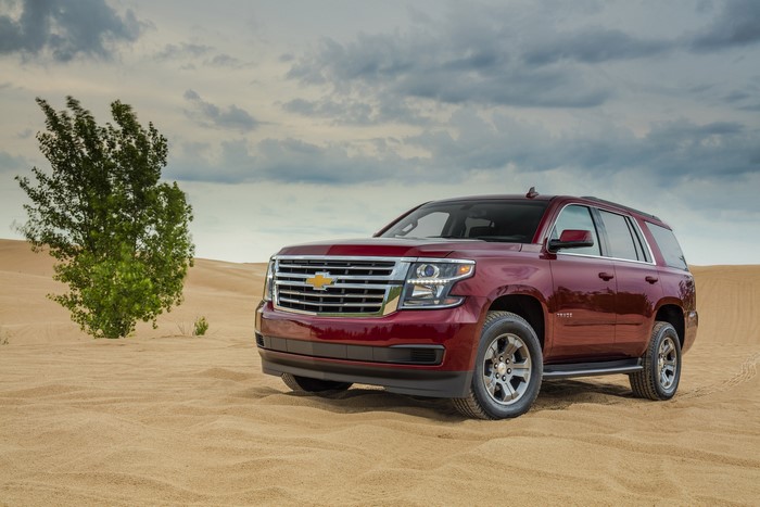 Red Chevrolet Tahoe SUV in a Sand Dune Landscape