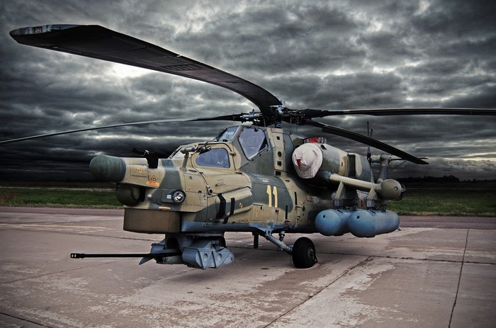 Mi-28N helicopter on tarmac under stormy sky