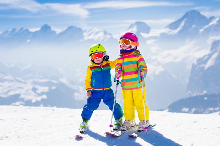 Two children skiing in the mountains
