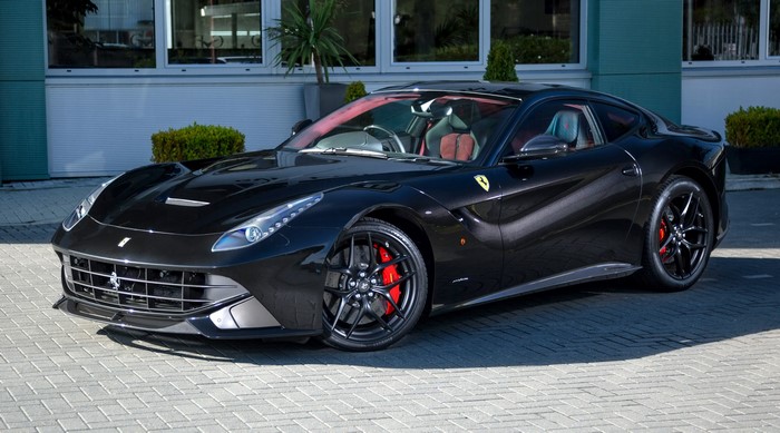 Black Ferrari F12berlinetta parked outside building