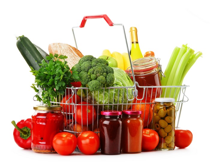 Shopping basket filled with fresh produce and jars