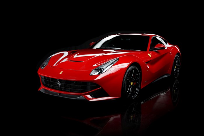 Red Ferrari F12berlinetta on black background
