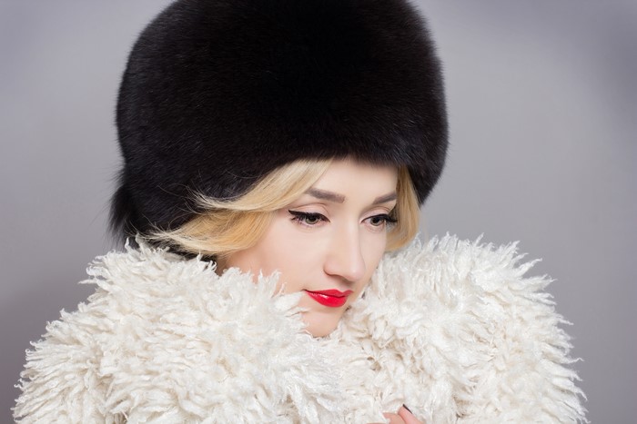 Blonde girl in winter hat and coat