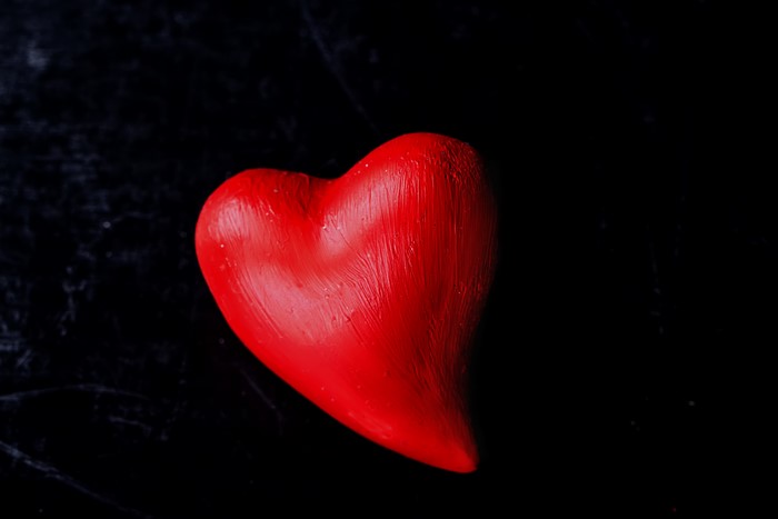 Red heart on black background