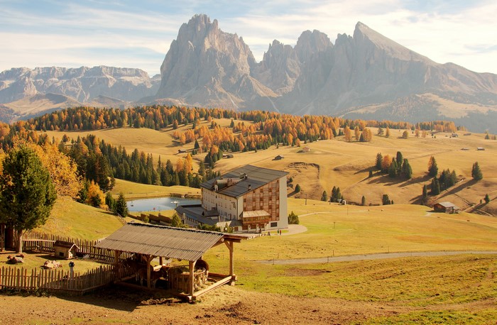 Autumn landscape in Seiser Alm, Italy with mountains and a hotel