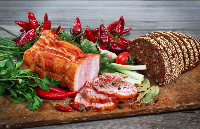 Ham, Bread, and Vegetables on a Cutting Board