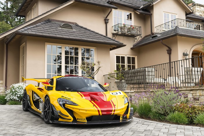 Yellow McLaren P1 GTR with Red Stripes in Front of House